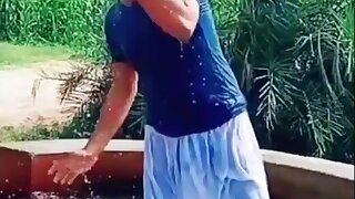 Pakistani bathing in tubewell